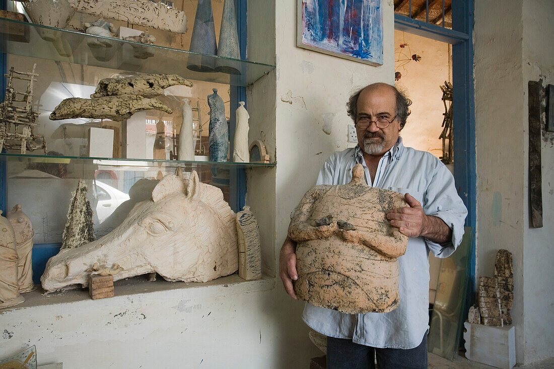 Artist with sculpture in his workshop, Larnaka, South Cyprus, Cyprus