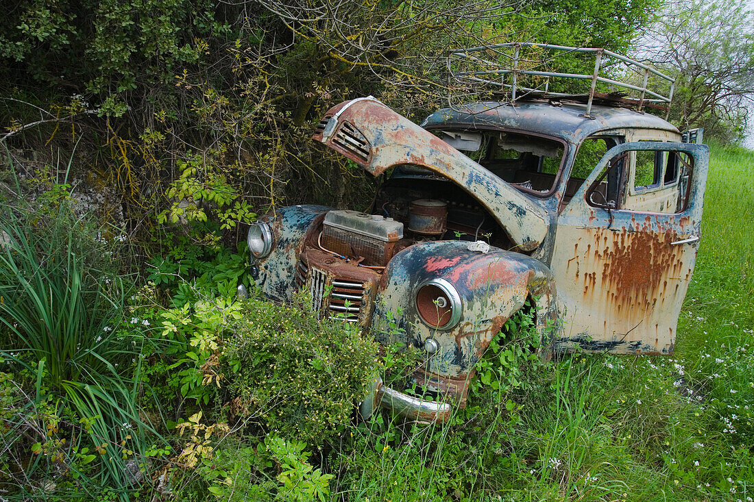 Old, derelict, wrecked car in a field, Troodos mountains, South Cyprus, Cyprus