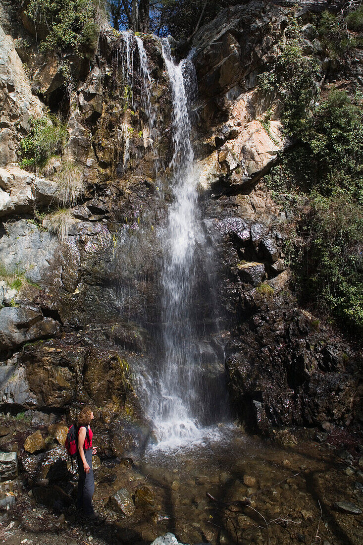 Woman hiking at the Kaledonia Waterfalls, near Pano Platres, Troodos mountains, South Cyprus, Cyprus