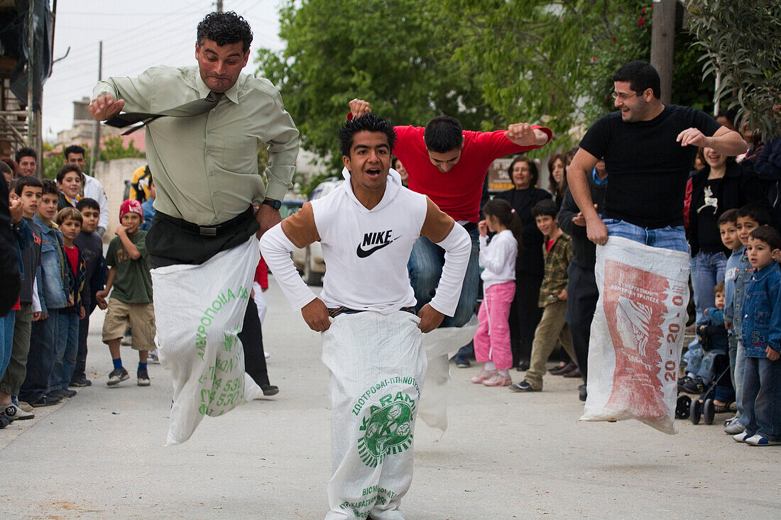 A group of men taking part in a sack race at the Easter games, Kathikas, South Cyprus, Cyprus