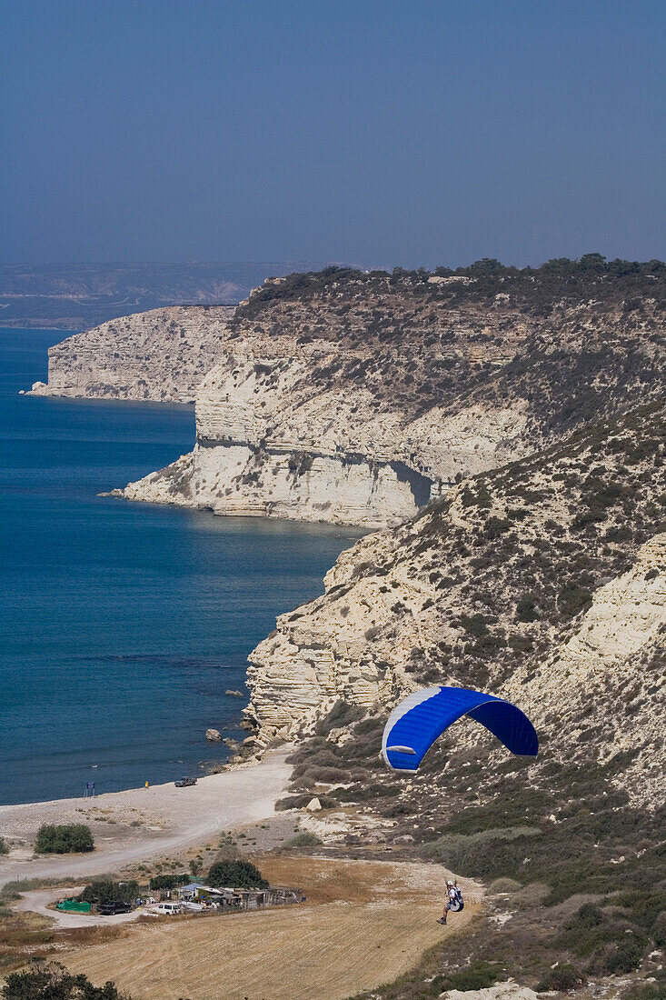 Paraglider over the steep rocky coast, Kourion, South Cyprus, Cyprus