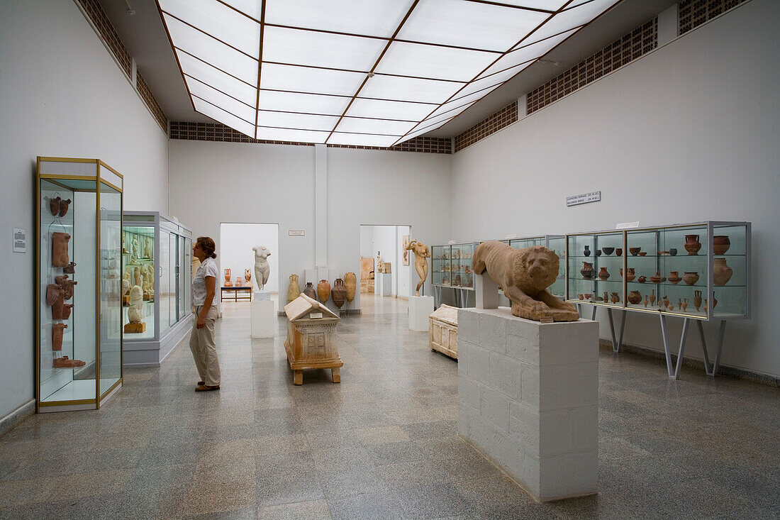 A man looking at exhibits in the Archaeological Museum, Pafos, South Cyprus, Cyprus