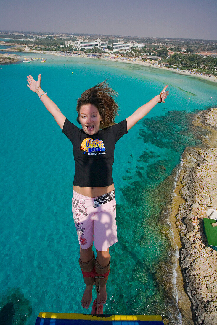 A young woman bungee jumping near Nissi Beach, Napa Bungee, Agia Napa, South Cyprus, Cyprus