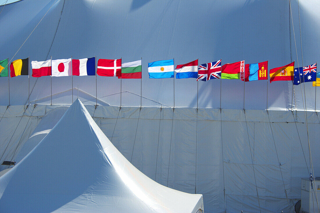 International Flags waving in the wind attached to Circus Tents in Amsterdam, Netherlands.