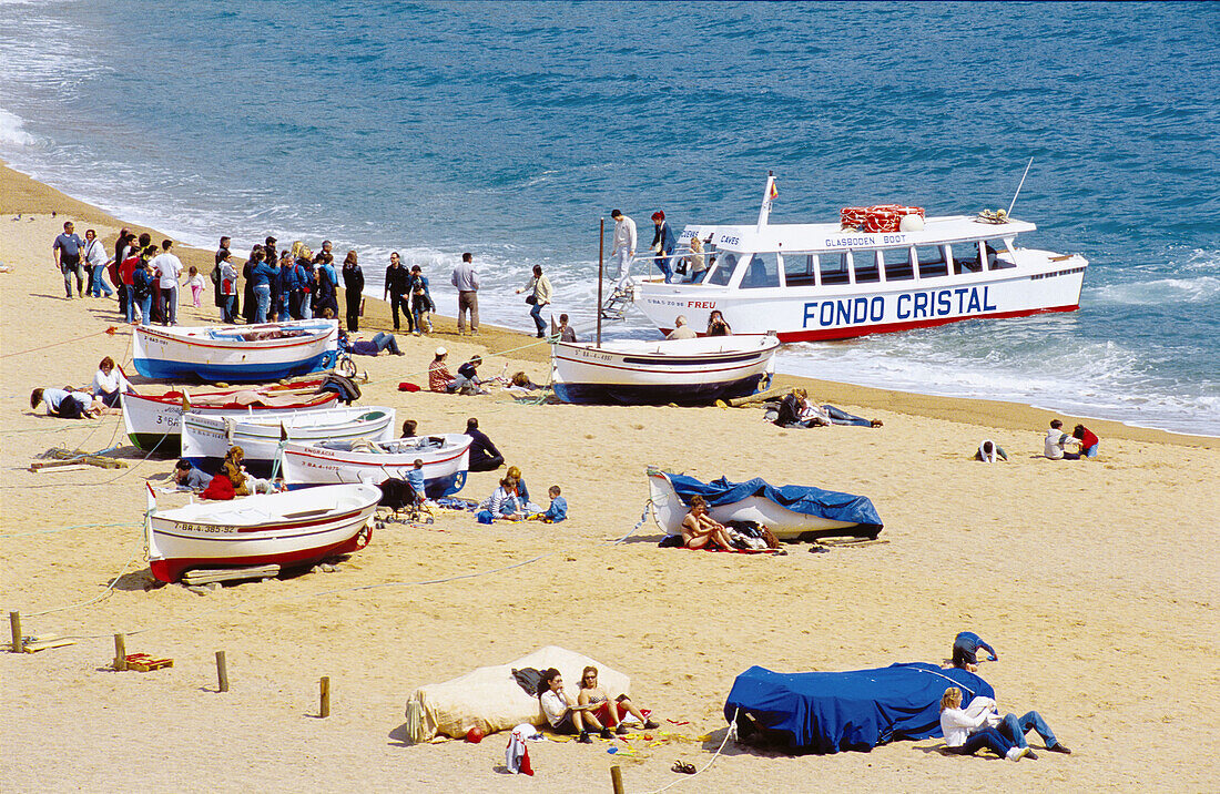 Tour boat at beach. Tossa de Mar, Costa Brava. Girona province, Spain