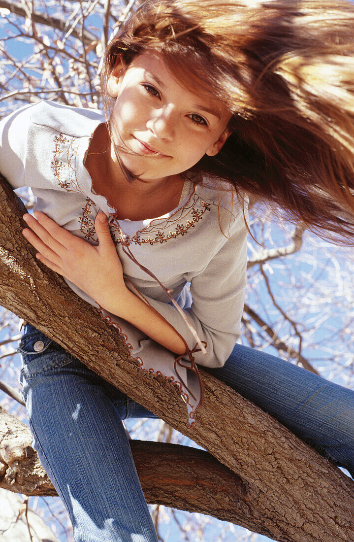 Girl inside down in a tree
