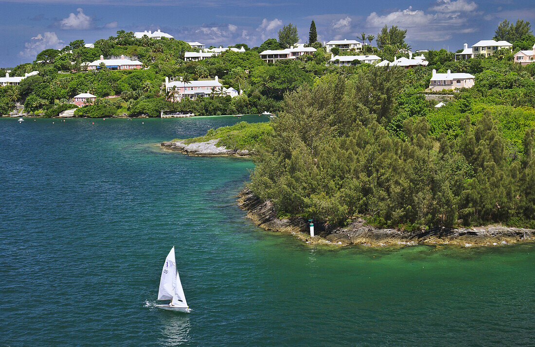 The Hamilton Bermuda shoreline with recreational sailboat.