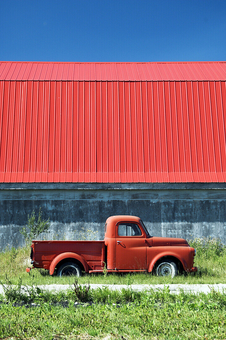 The color of red in an old truck and barn roof near Isle de Chênes, Manitoba. Canada.