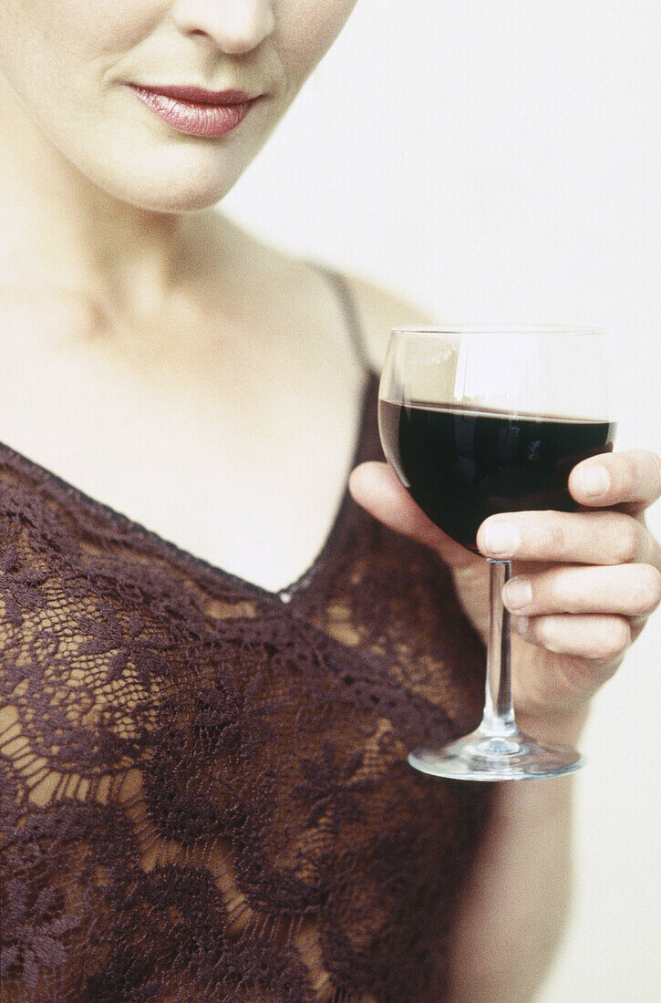 close up image of woman holding glass of wine