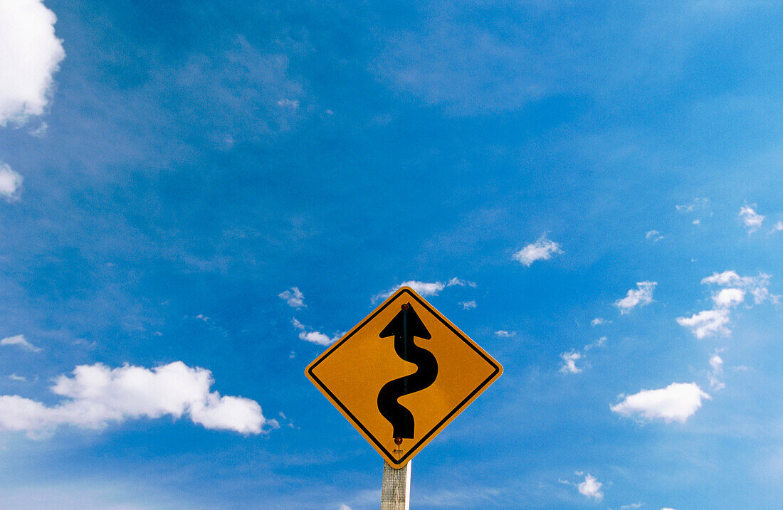 Road Sign With Blue Sky and Clouds