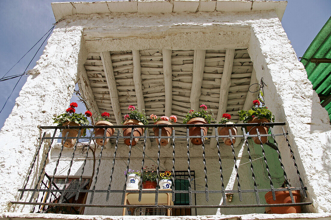Terrace with bars and flower pots in a typical house in Pampaneira. Alpujarras Mountains area, Granada province. Spain