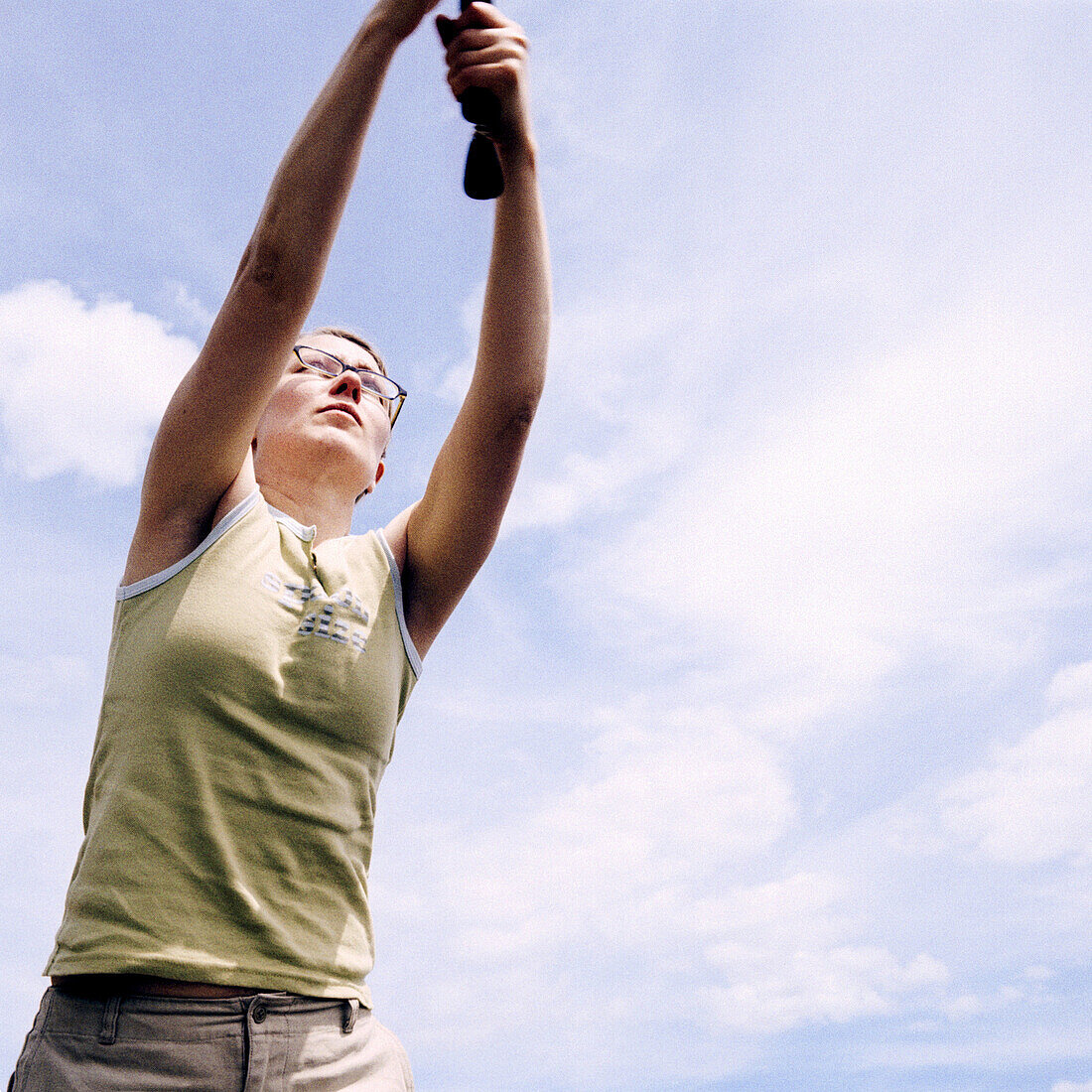 Adolescent, Adolescents, Arm, Arms, Blue, Blue sky, Cloud, Clouds, Color, Colour, Concentrate, Concentrating, Concentration, Contemporary, Daytime, Determination, Exterior, Female, Girl, Girls, Hold