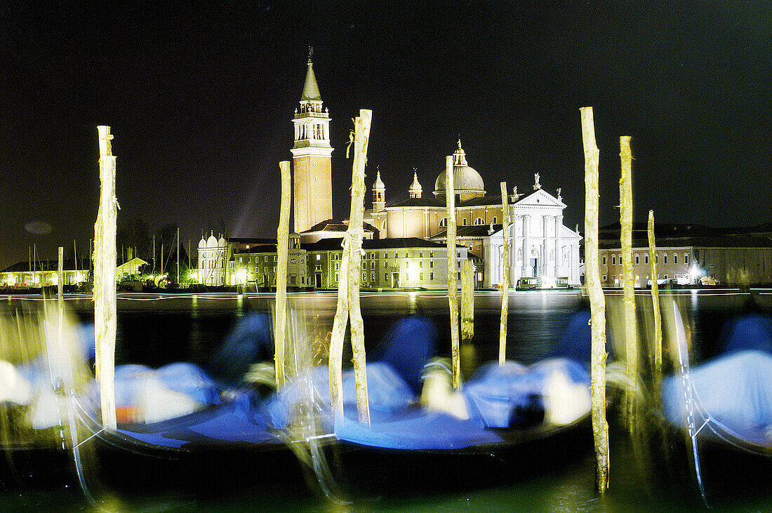 Gondolas at St. Mark s pier with San Giorgio Maggiore church in background at night. Venice. Italy