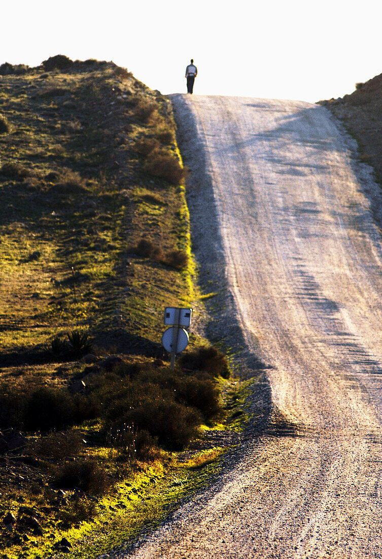 Silhouette of man walking along country path. Cabo de Gata. Andalucia. Spain