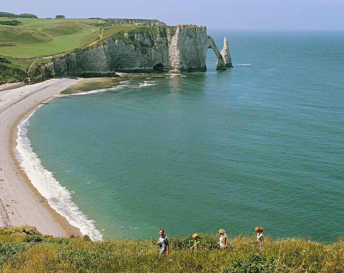 People walking along cliffs at Etretat. Etretat. Normandy. France