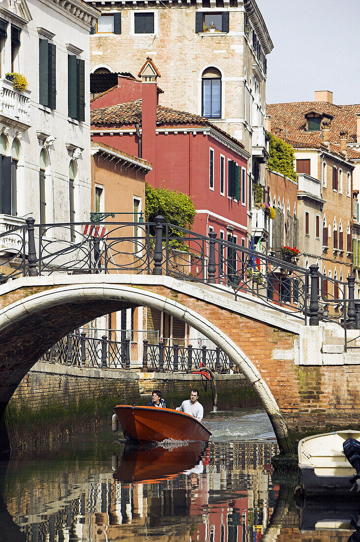 Canal with bridge and boat. Venice. Italy