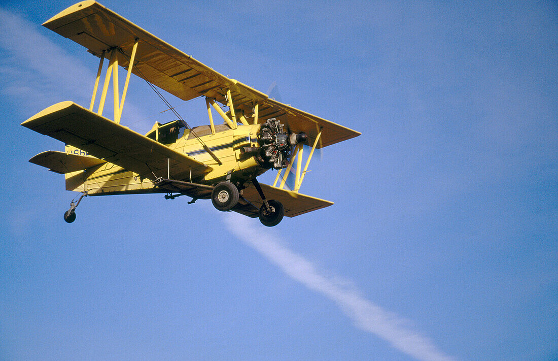 Crop duster approaches for landing at an airstrip just North of Oaksdale. Withman County, Washington, USA