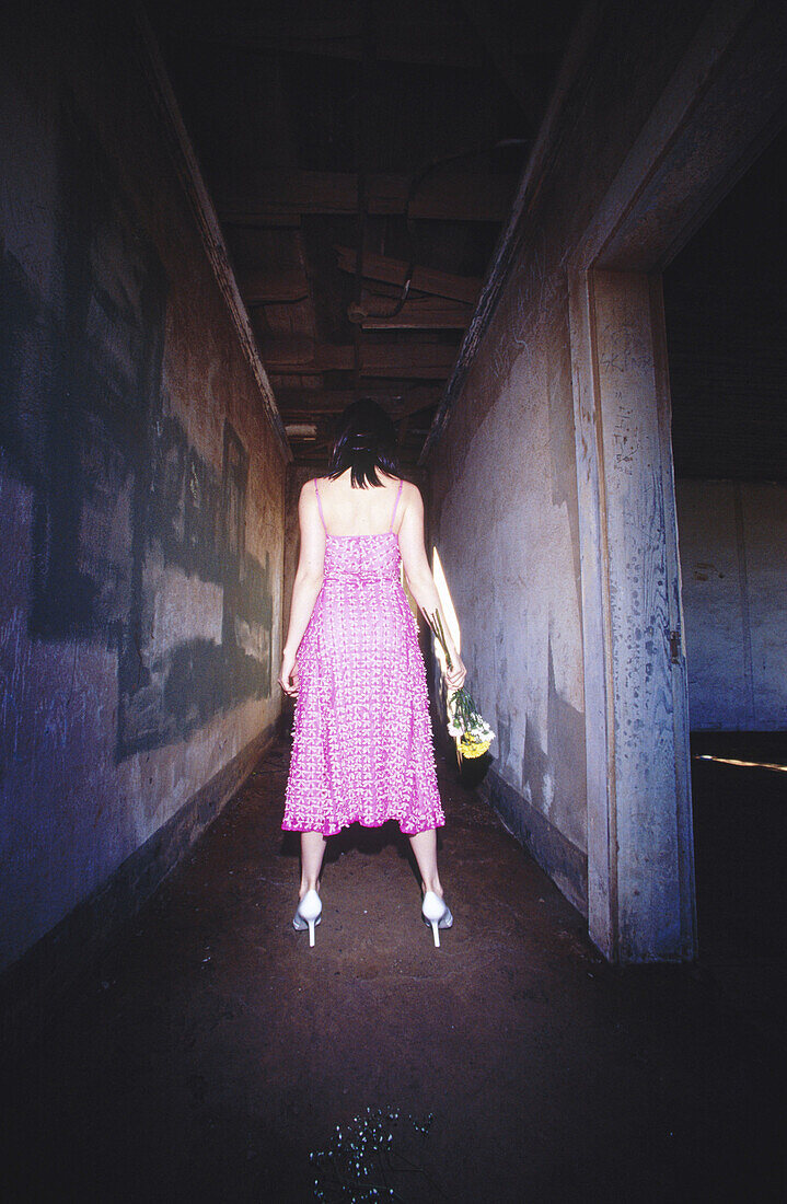 Woman in dark corridor