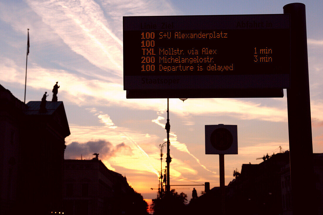 Bus stop with passenger information display, dusk, Unter den Linden, Berlin, Germany