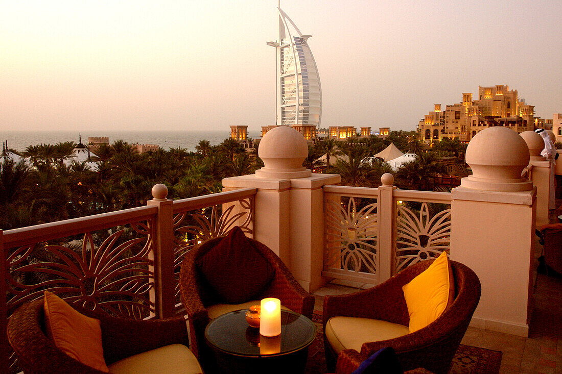 Outdoor Seating at restaurant terrace at dusk, Al Qasr hotel, View at Burj Al Arab Hotel, Madinat Jumeirah, Dubai, United Arab Emirates, UAE