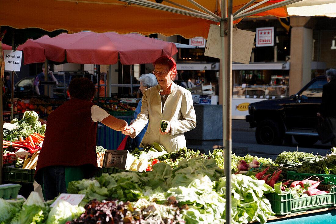 Woman buying fresh vegetables and fruit at a market stall, Market, Marktplatz, Basel, Switzerland