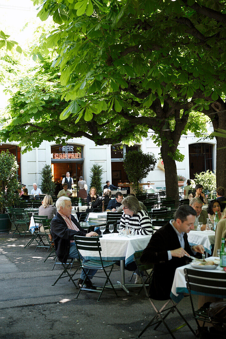 People sitting at tables outside Campari Bar, Theaterplatz, Basel, Switzerland