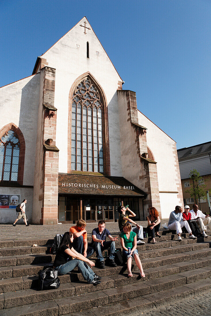 People sitting on steps in front of a church, Barfuesser Church, Historical Museum, Barfuesserplatz, Basel, Switzerland