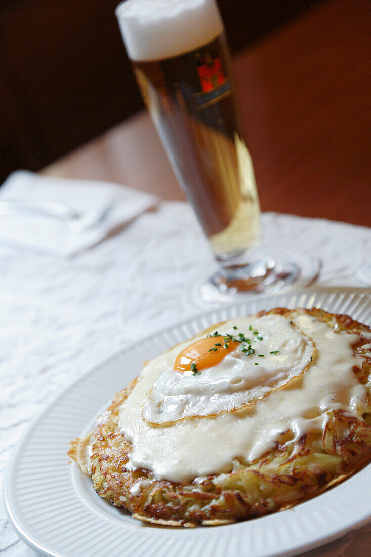 Close up of a roesti, potatoe dish, and a beer in Restaurant Hasenburg, Basel, Switzerland