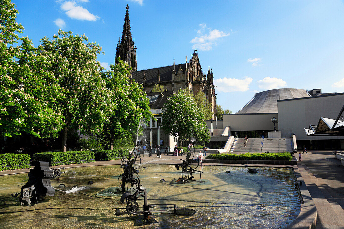 Fountain, Jean Tinguely Brunnen, with church, Katharinenkirche and Theatre, Theaterplatz, Basel, Switzerland