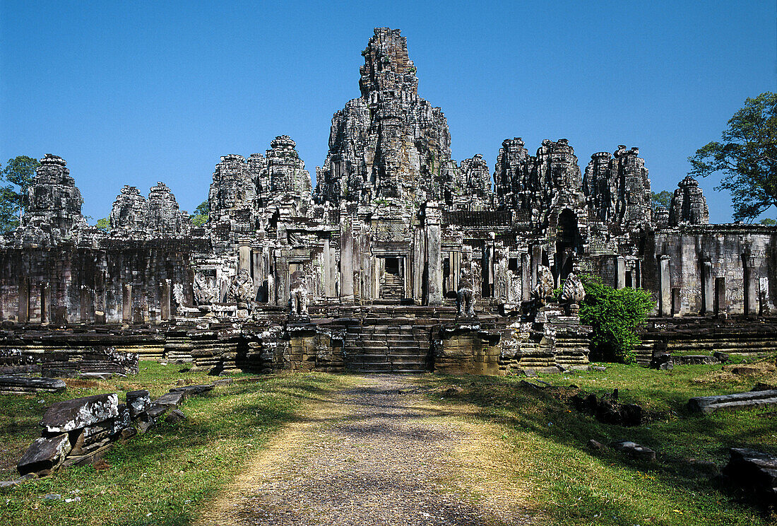 Temple city of Angkor Thom: side view of Angkor Thom temple with its Bayon in the middle which features the famous smiling faces -in each direction one-. Temple complex of Angkor, Siem Riep, Cambodia