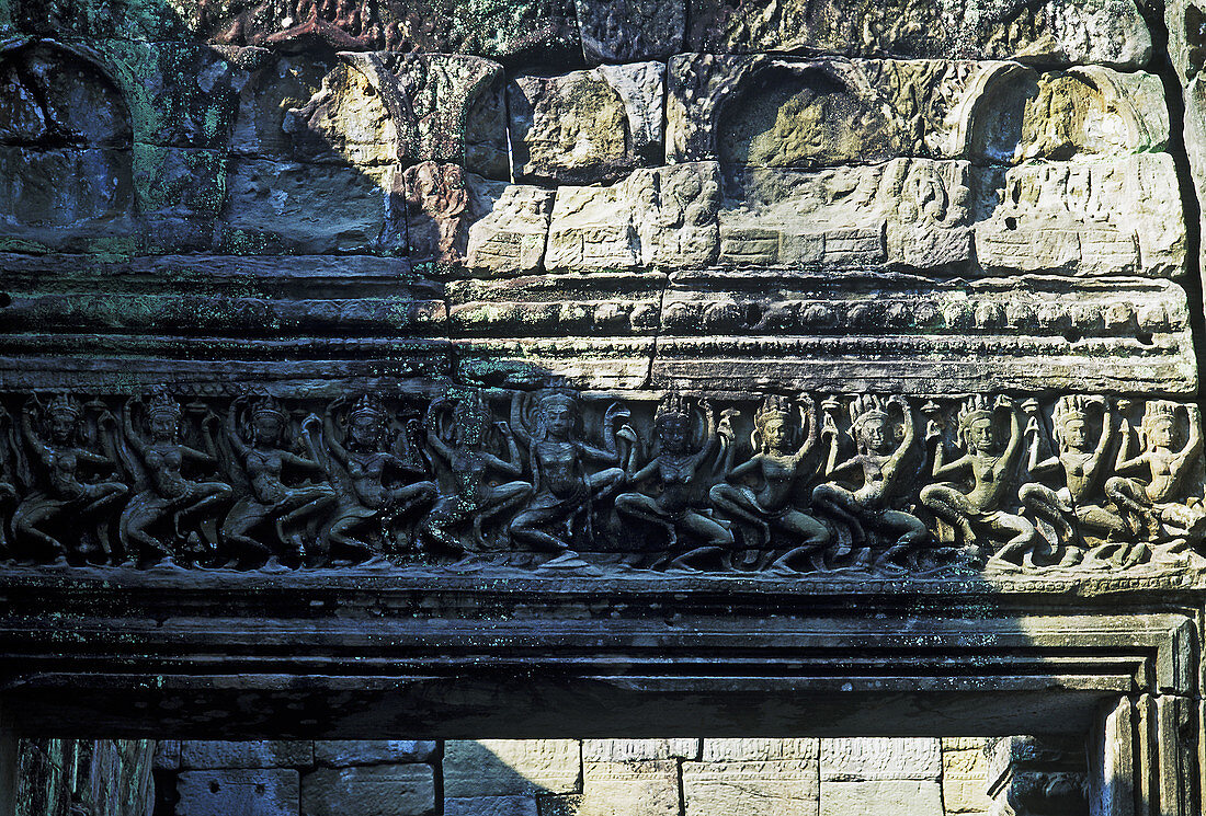 Dancing Apsaras carved as relief at the top of the door frame of Preah Khan temple, temple complex of Angkor. Siem Riep, Cambodia