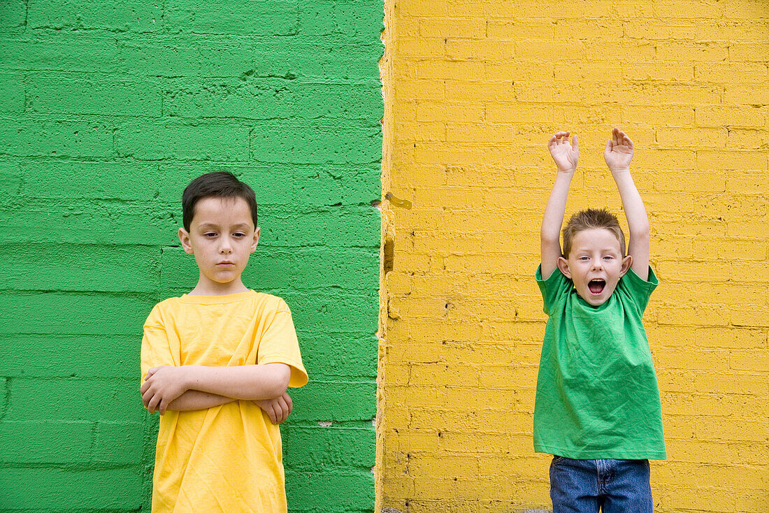 Two boys against colorful yellow and green wall