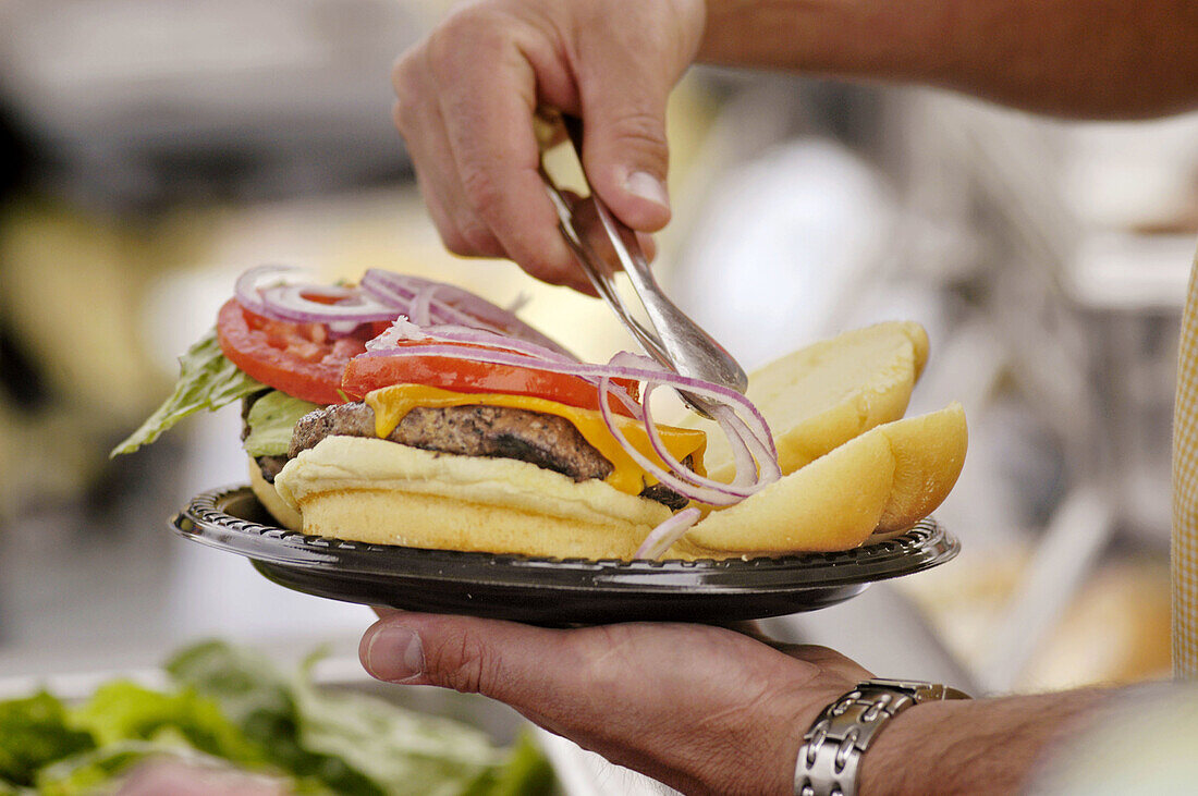 Hamburgers and Hotdogs. Cooking on Bar-B-Q at Club cookout for kids and families.