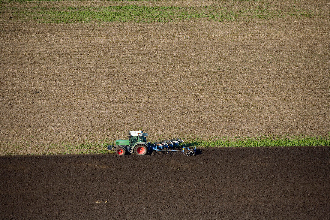 aerial view of tractor ploughing fields, Lower Saxony