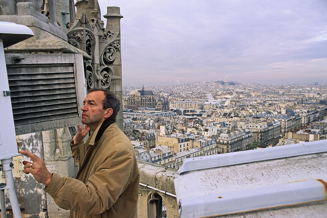 Man measuring the level of environmental polution, Saint Jacques Tower, gothic tower, 4e Arrondissement, Paris France