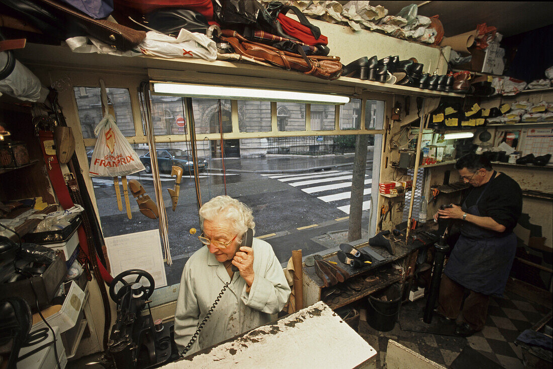Shoemaker repairing shoes, Paris, France