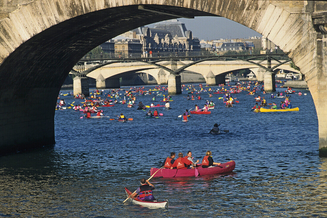 People in kayaks and canoes on the Seine river, Paris, France, Europe