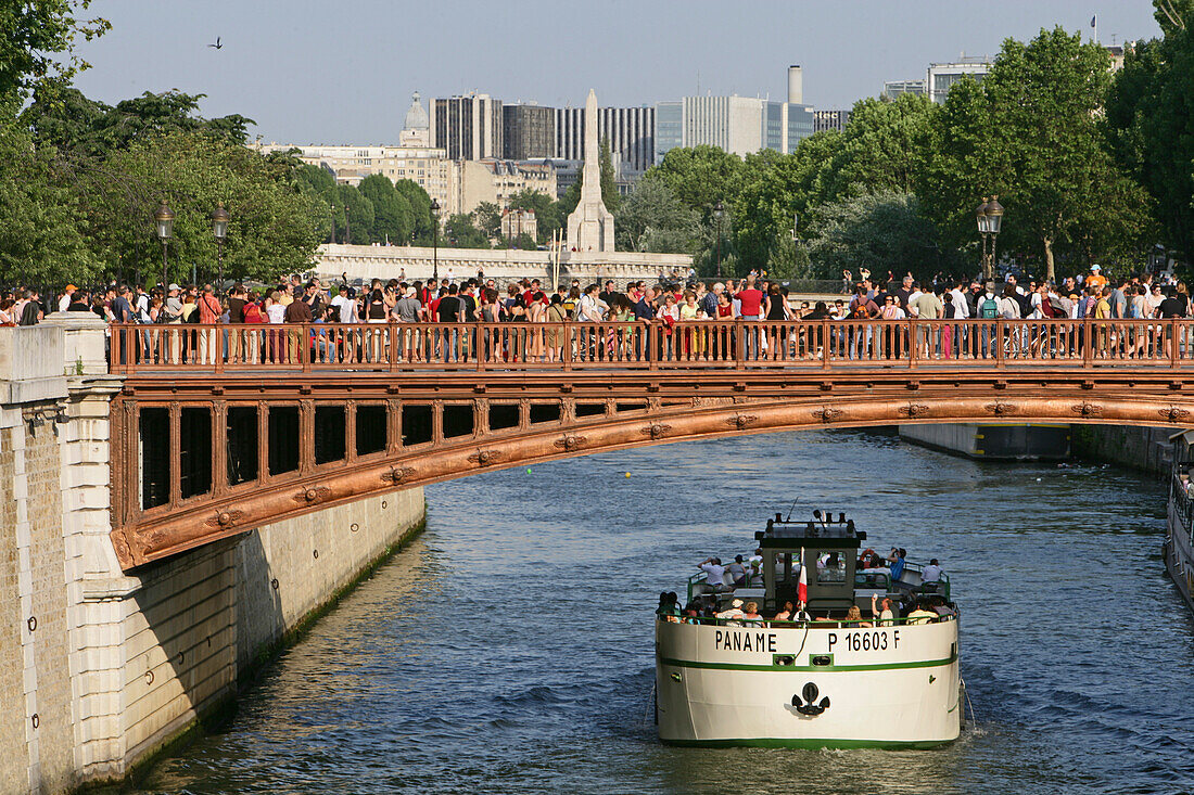 People on a bridge above the river Seine, Paris, France, Europe