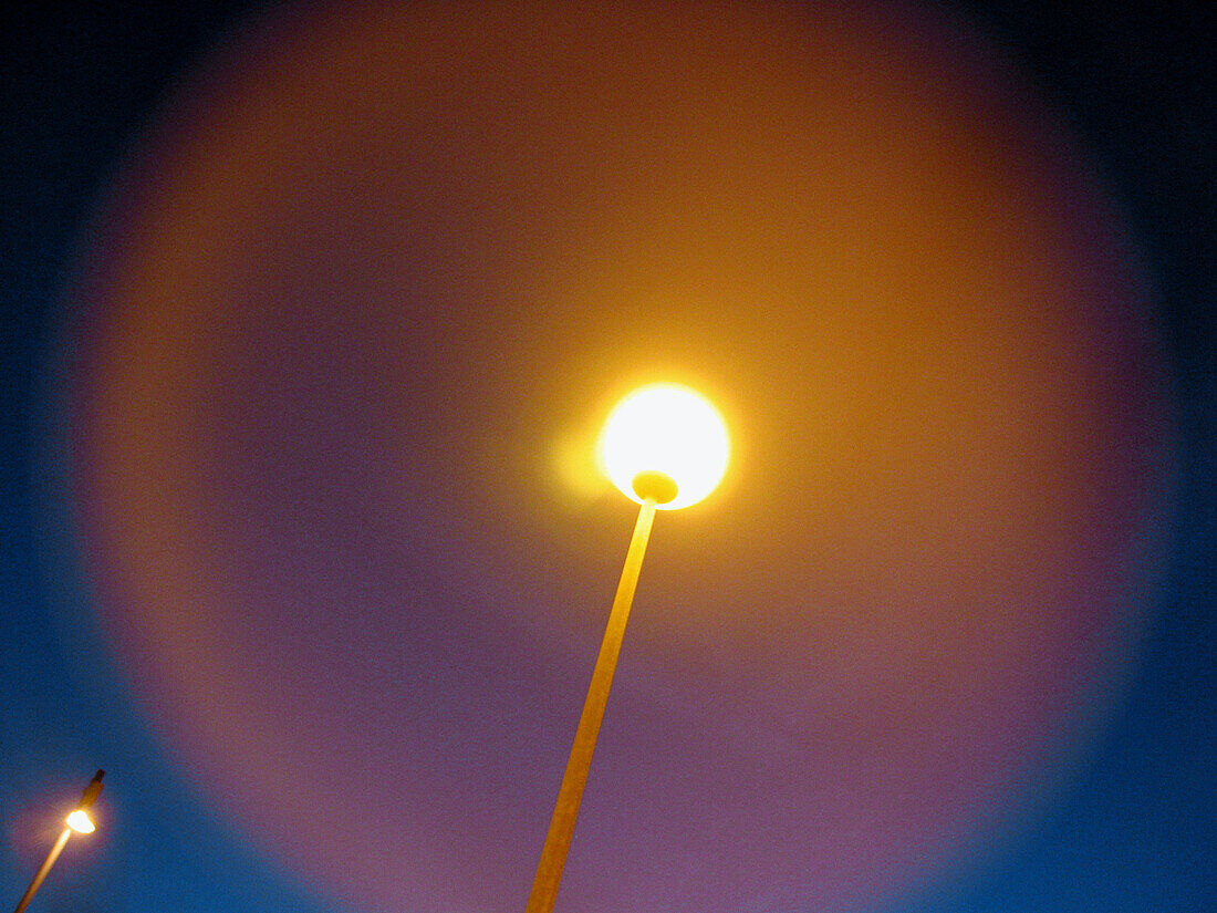 Center, Centre, Color, Colour, Concept, Concepts, Electricity, Energy, Exterior, Horizontal, Light, Low angle view, Night, Nighttime, One, Outdoor, Outdoors, Outside, Power, Round, Special effects, Street lamp, Street lamps, Symbolic, View from below, Wor