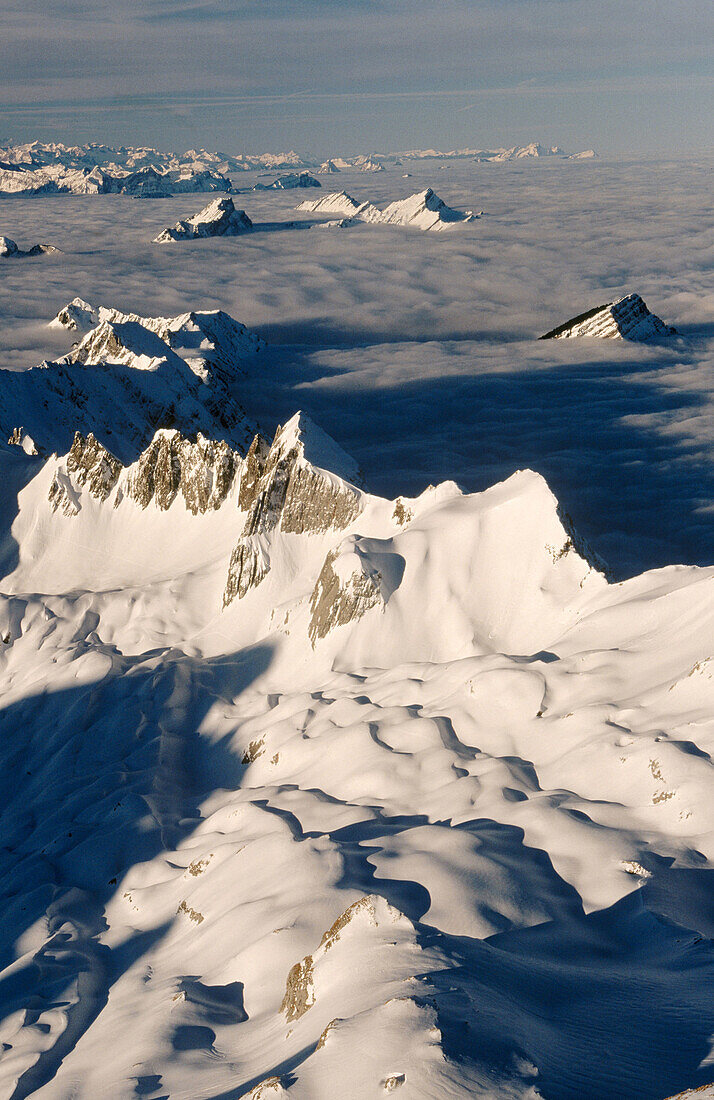 Mount Stoss or Silberplatte with Alps as backdrop with fog. View from the Saentis. Appenzell. Switzerland.