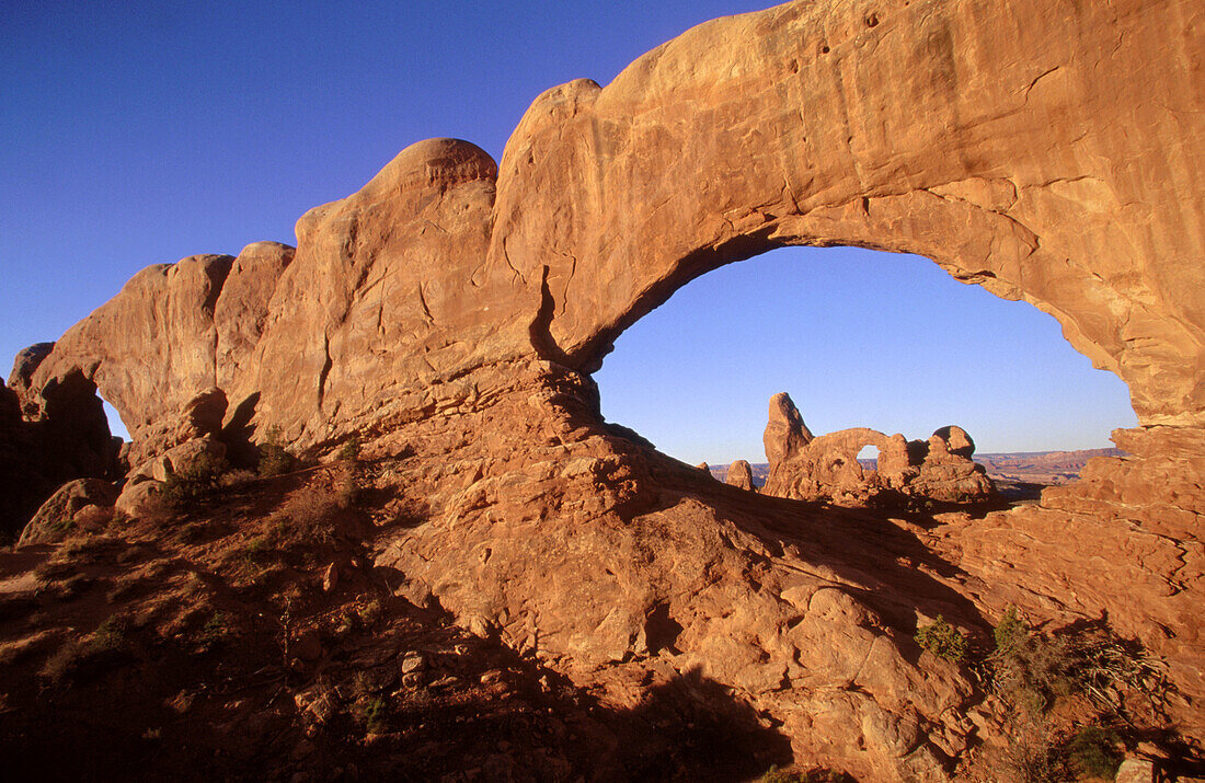 Natural stone arch. Turret Arch seen through North Window. North and South Window. Arches National Park. Utah. USA.