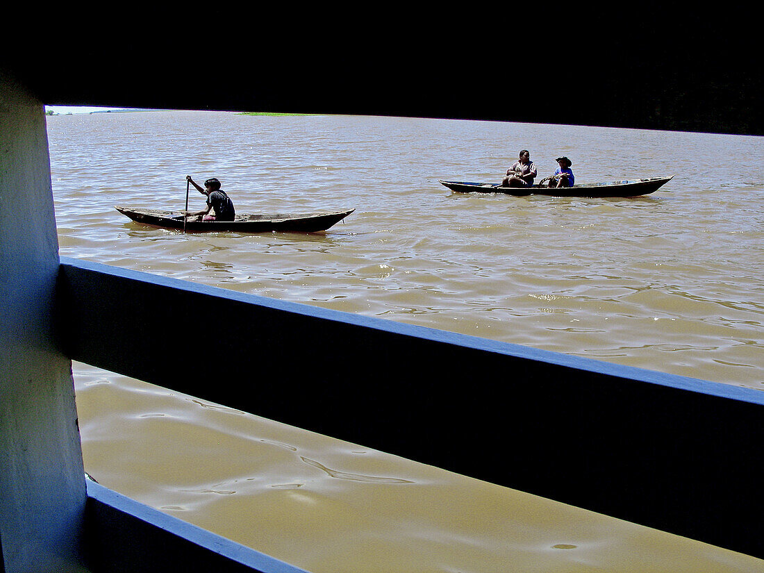 Canoes approaching boat. Amazon River. Brazil