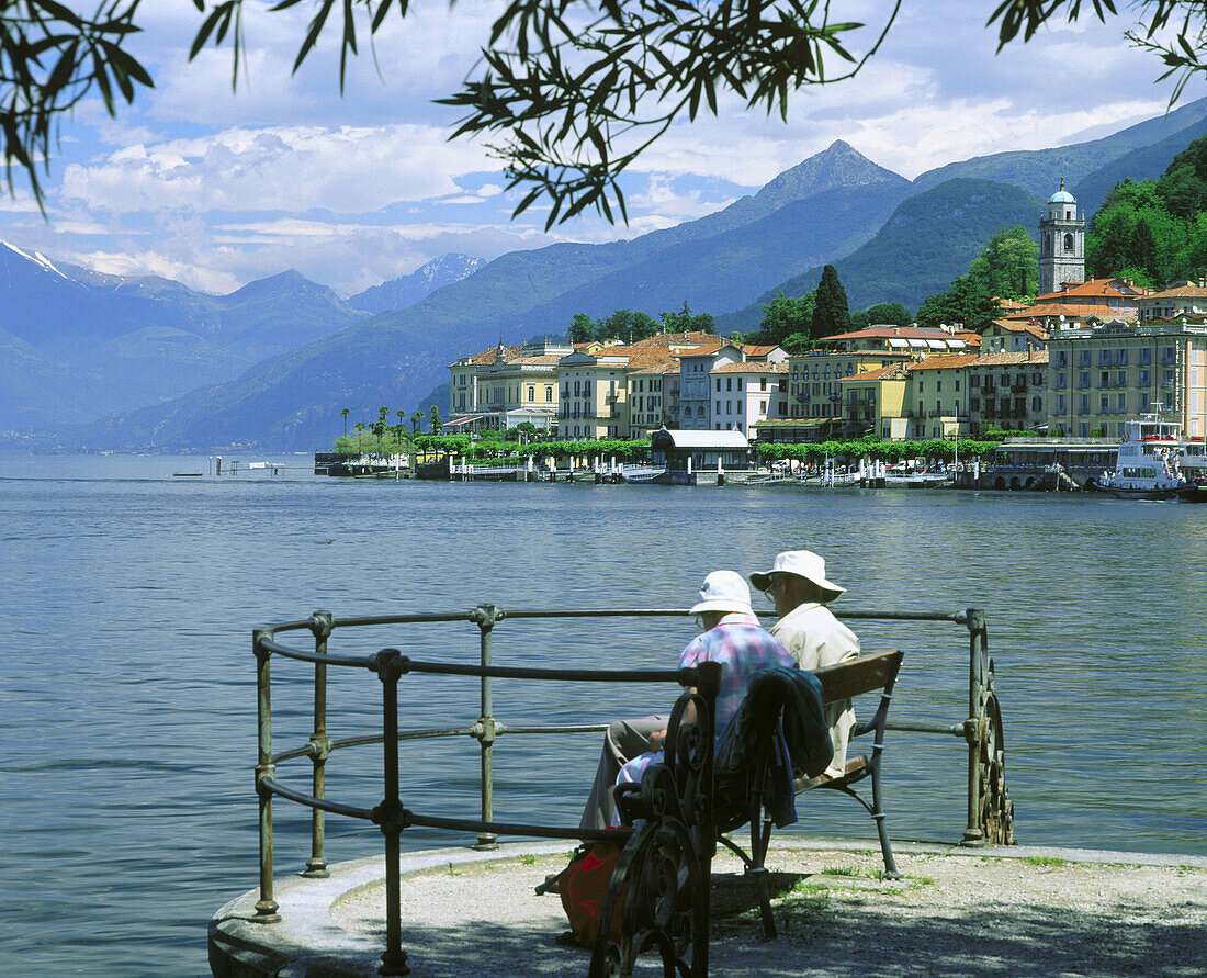 Older couple in park bench overlooking Lake Como. Bellagio. Lombardia. Italy