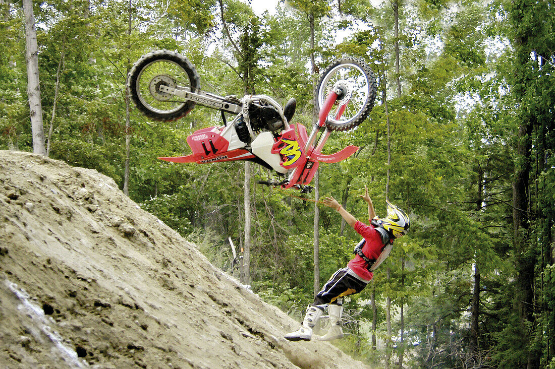 Motorcycle riders with protective gear participe in a hill climb competition