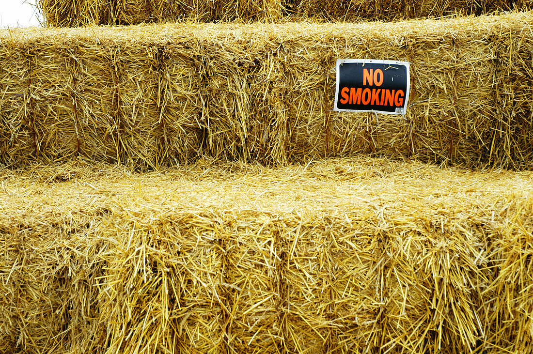 No smoking signs placed on bails of hay