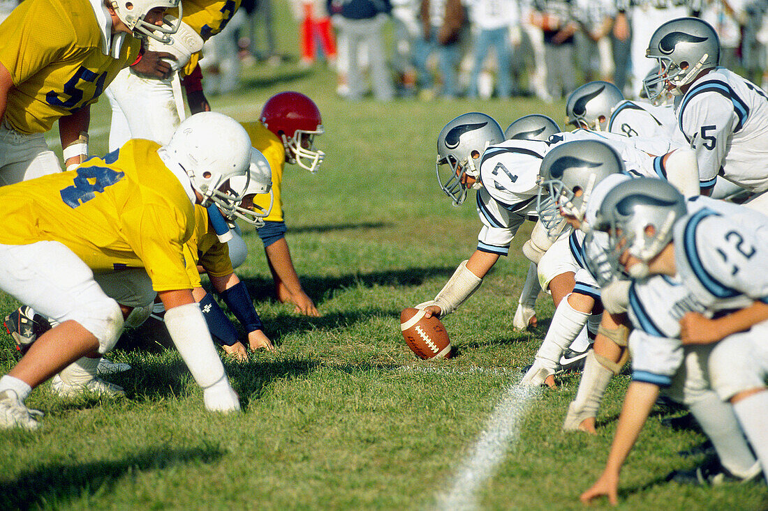 The line of scrimage of a junior varsity football game made up of 9th and 10th grade student