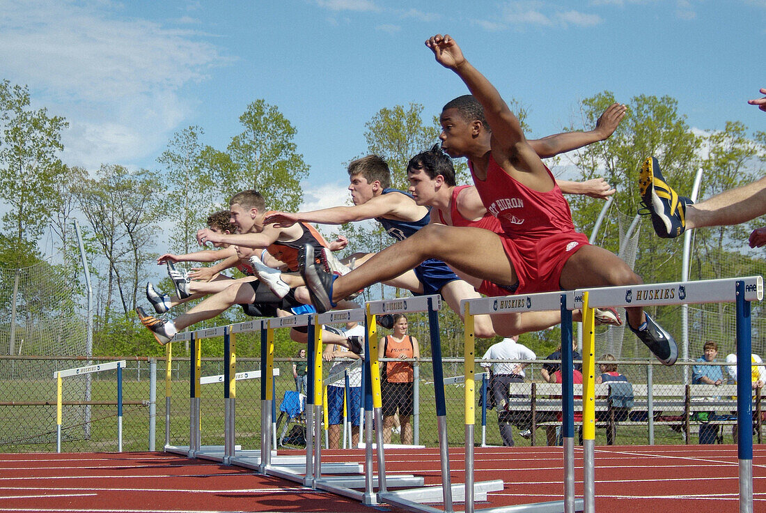 High School Track and Field event: jumping the hurdles