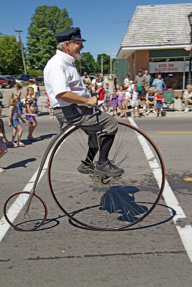 High wheeler vintage historic bicycle at Independence Day parade, Lexington. Michigan, USA