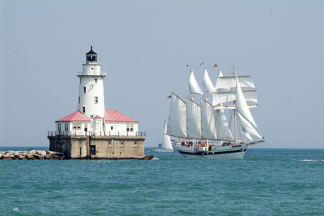 Downtown city of Chicago with the lighthouse guarding Chicago Harbour and the tall ship Windy. Chicago, Illinois. USA.