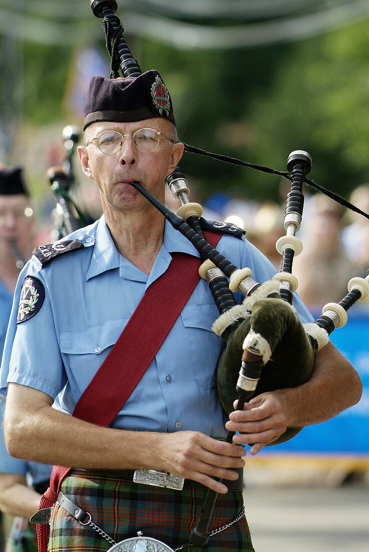 Portrait of Bag pipers playing music as they march in a parade